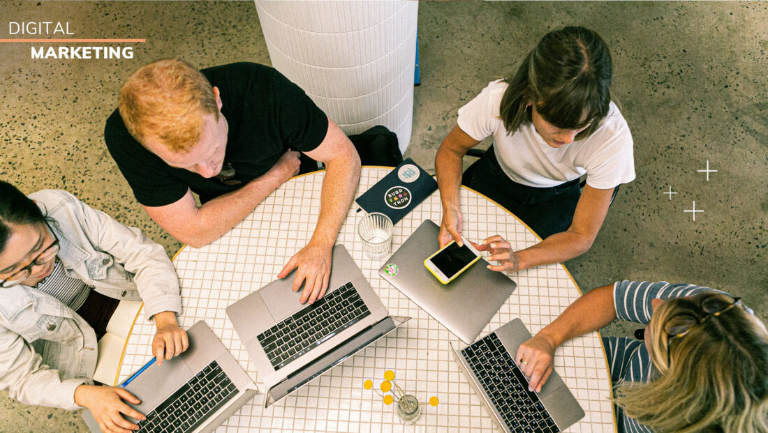 Digital Marketing image of four people working on a project at a table
