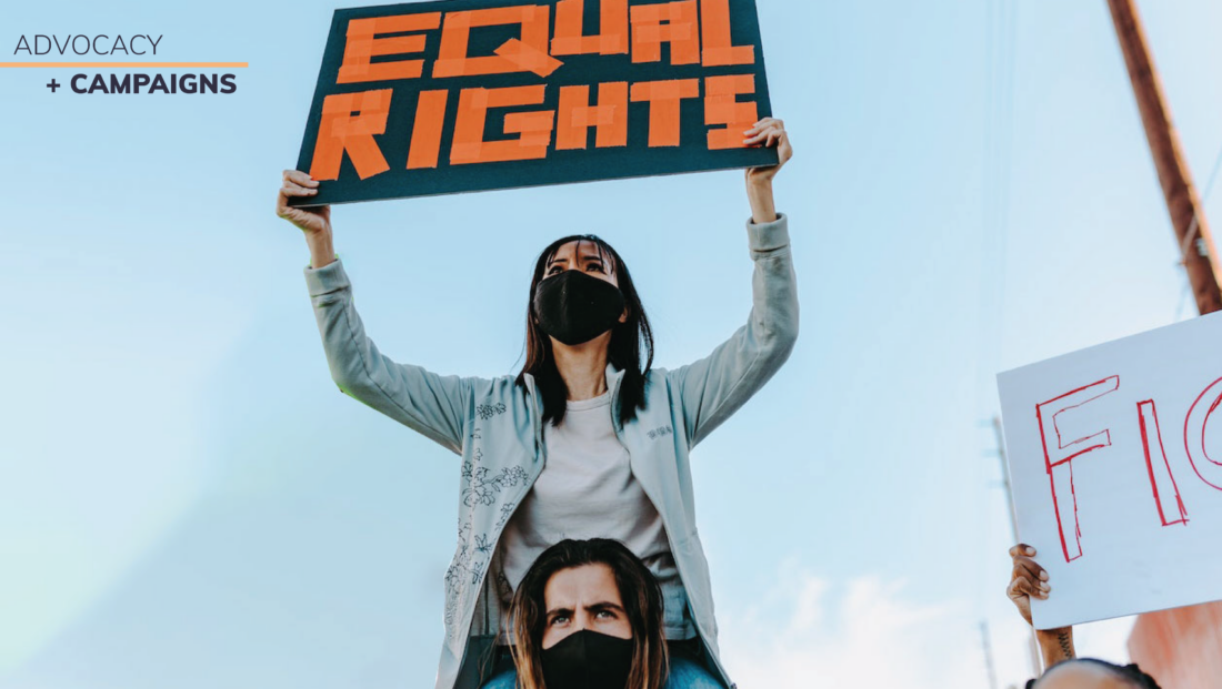 Woman holding up a sign that says "Equal rights"