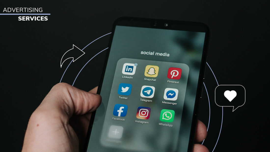 Image of a person holding an iPhone with the screen showing social apps and text "Advertising Services" directed towards social media advertising