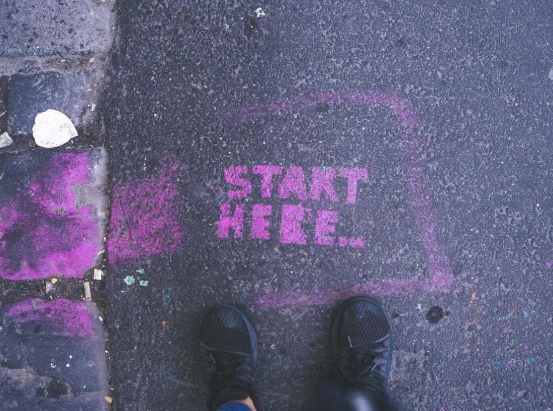 "Start here" stenciled on the ground