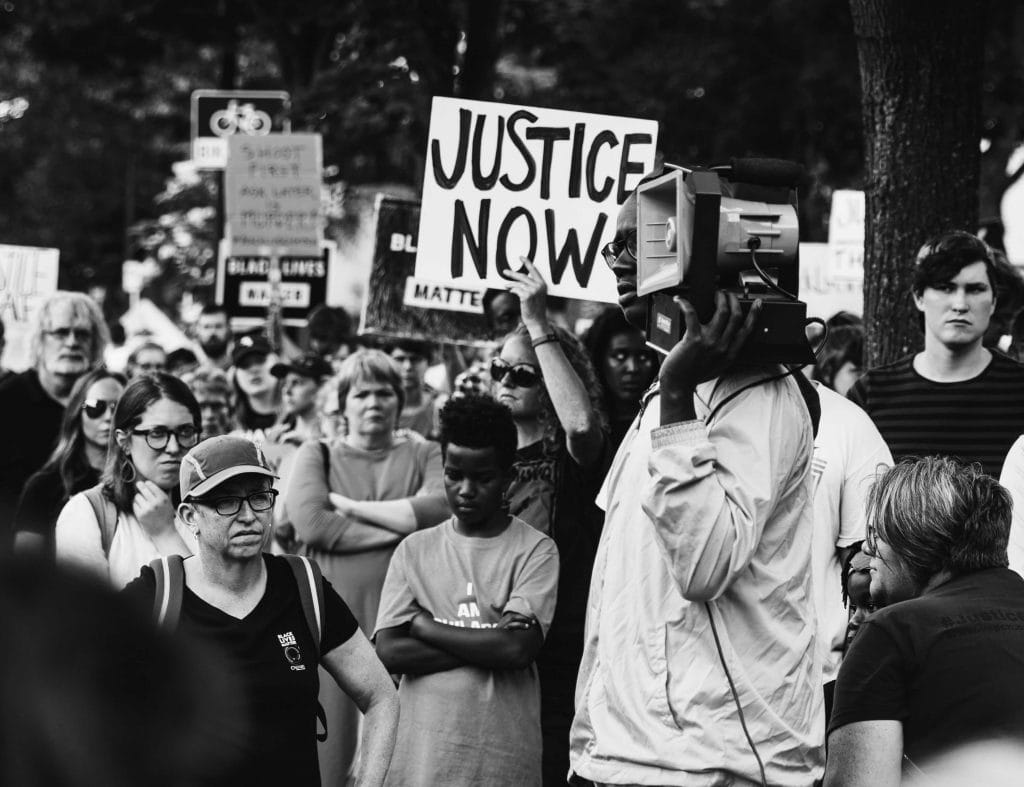 Justice Now sign at march