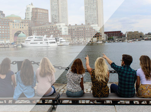 Image of seven Media Cause team members sitting in a row looking out over the city