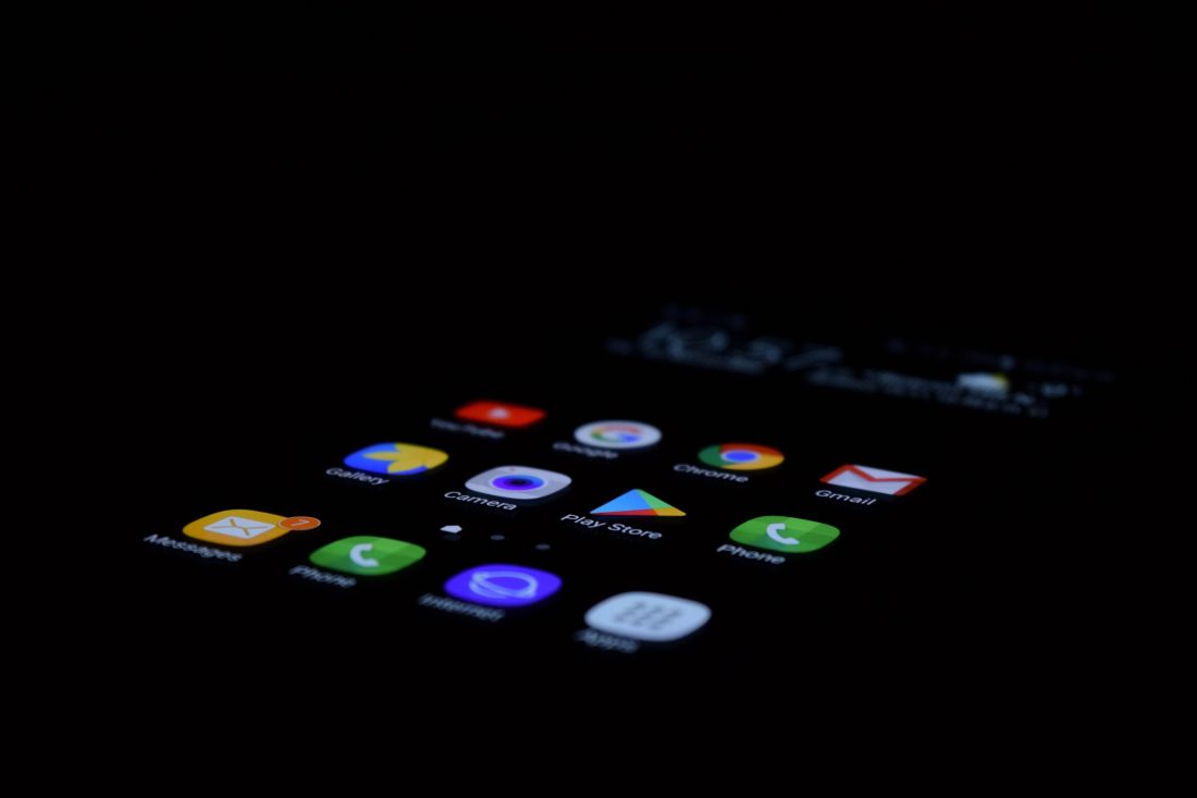 app logos on screen lit up in dark