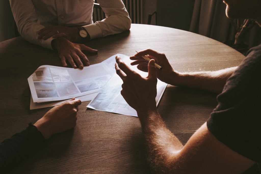 people sitting at a table with paper in front of them