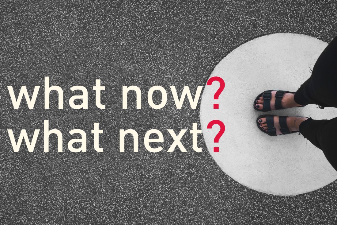person in sandals with feet on ground in circle. text that reads "what now? what next?"